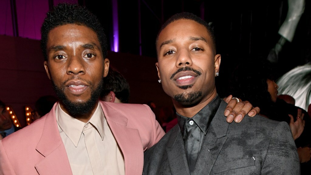 Chadwick Boseman and Michael B. Jordan pose for a photo at a party.