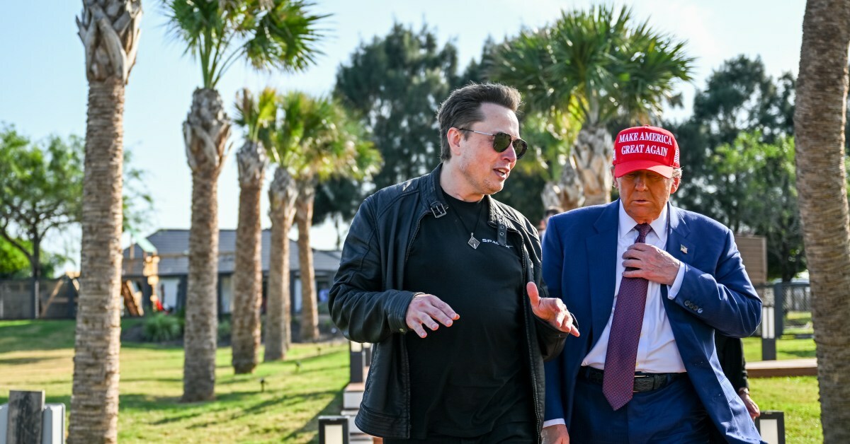 Elon Musk walks beside Donald Trump