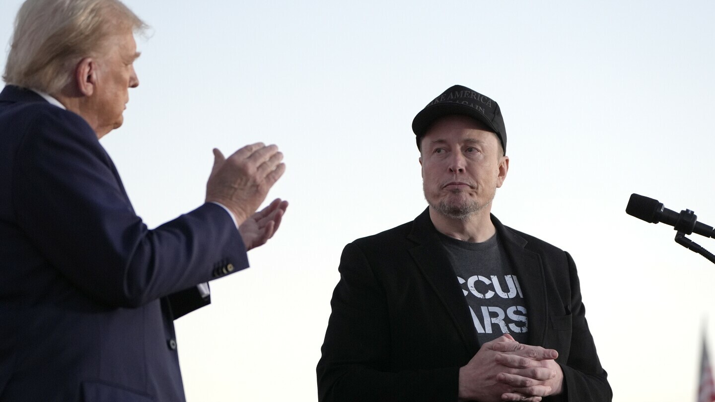 Republican presidential nominee former President Donald Trump, left, claps as Tesla and SpaceX CEO Elon Musk prepares to depart after speaking at a campaign event at the Butler Farm Show, on Oct. 5, 2024, in Butler, Pa. (AP Photo/Alex Brandon, File)