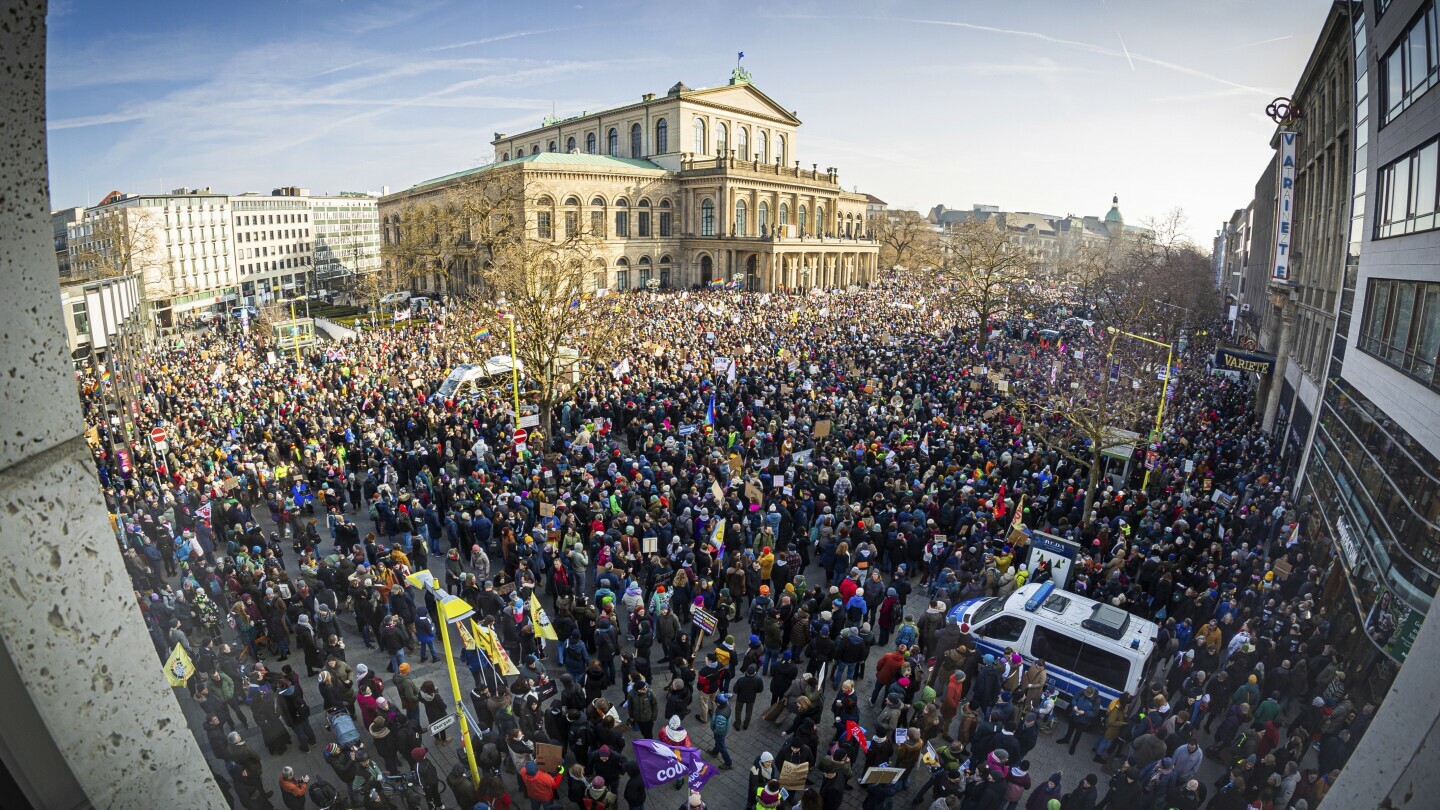 People gather to take part in the demonstration against right-wing extremism, in Hanover, Germany, Saturday Feb. 8, 2025. (Moritz Frankenberg/dpa via AP)