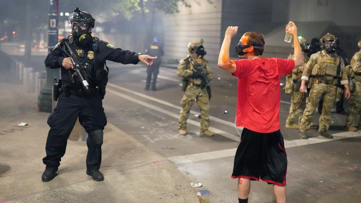 A federal officer tells fellow officers to arrest a protester in front of the Mark O. Hatfield U.S. Courthouse on July 21, 2020 in Portland, Oregon.
