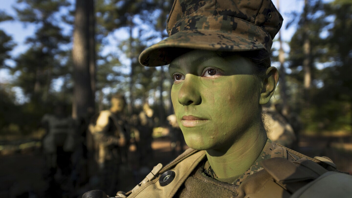 In this image provided by the U.S. Marine Corps, Pfc. Christina Fuentes Montenegro prepares to hike to her platoon's defensive position during patrol week of Infantry Training Battalion near Camp Geiger, N.C. Oct. 31, 2013. (Sgt. Tyler Main/U.S. Marine Corps via AP)