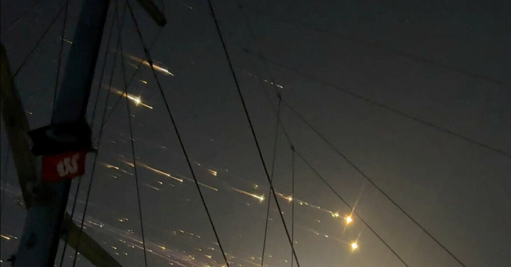 A view shows debris streaking through the sky, after SpaceX’s Starship spacecraft tumbled and exploded in space, in Hog Cay, Bahamas.