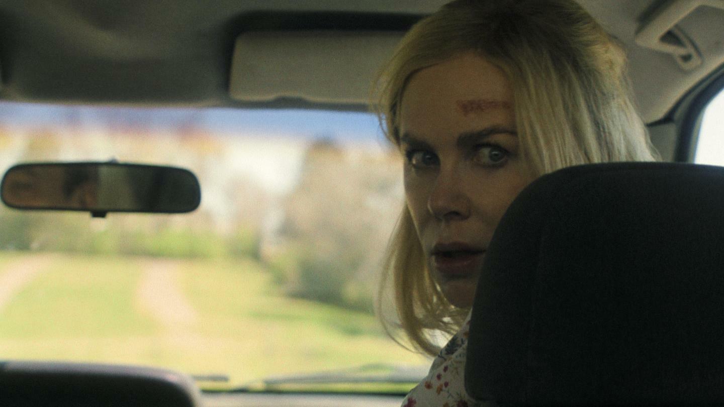 Nicole Kidman, as Nancy Vandergroot, stares in horror at someone in the backseat of a car.