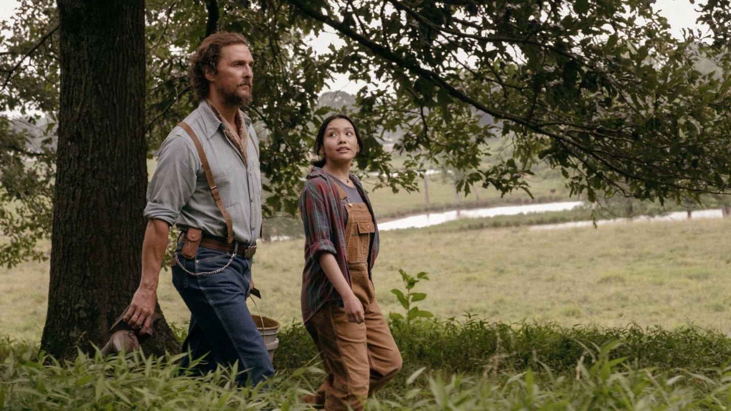 Matthew McConaughey and Angelina LookingGlass, walking through grasslands, in Andrew Patterson's 'The Rivals of Amziah King.'