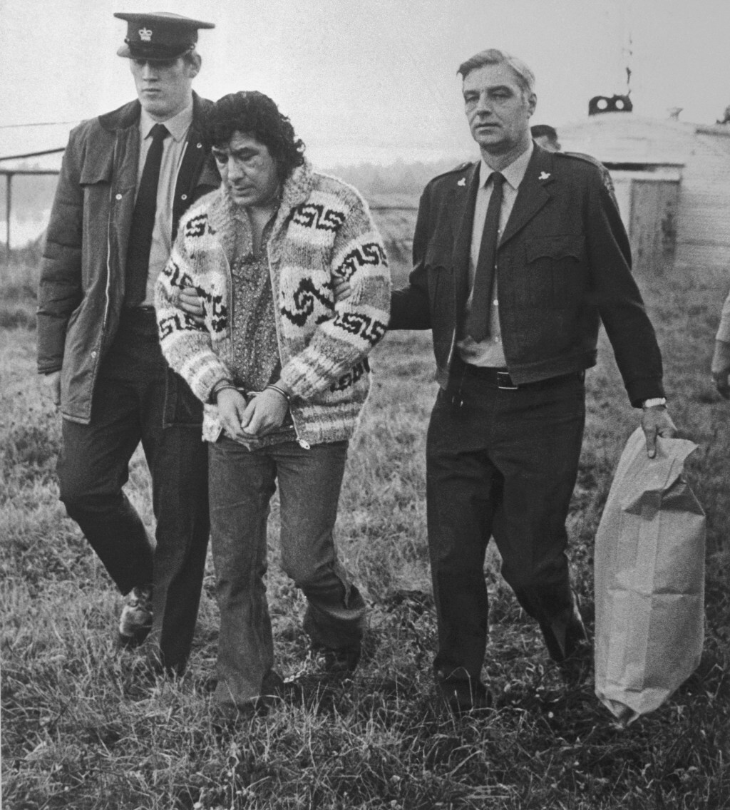 Leonard Peltier, American Indian Movement leader, is led across Okalla prison exercise yard