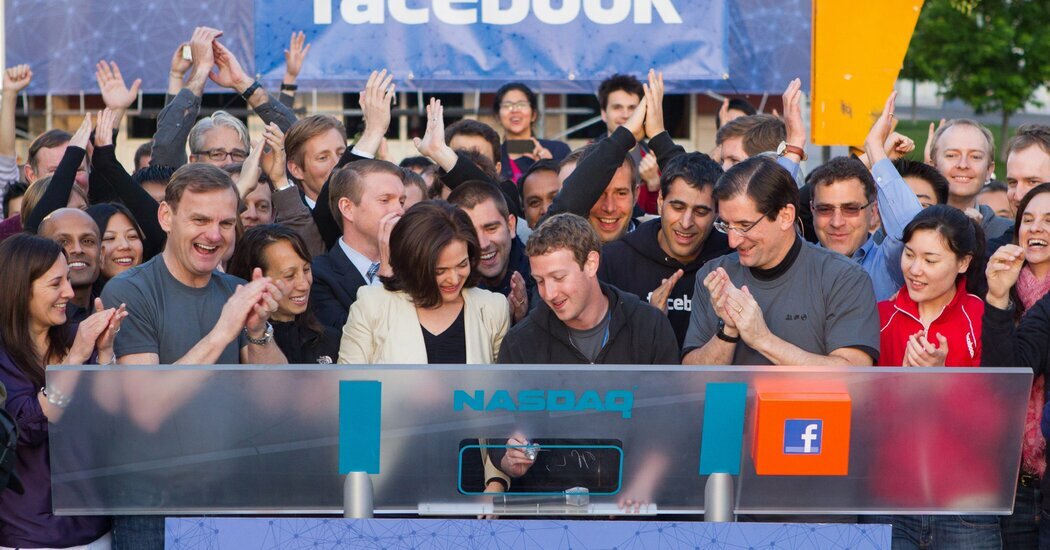Facebook’s C.E.O. Mark Zuckerberg rings the Nasdaq’s opening bell from Facebook’s headquarters in Menlo Park, Calif., on May 18, 2012, the day of the company’s initial public offering, while Sheryl Sandberg, Facebook’s C.O.O., looks on.