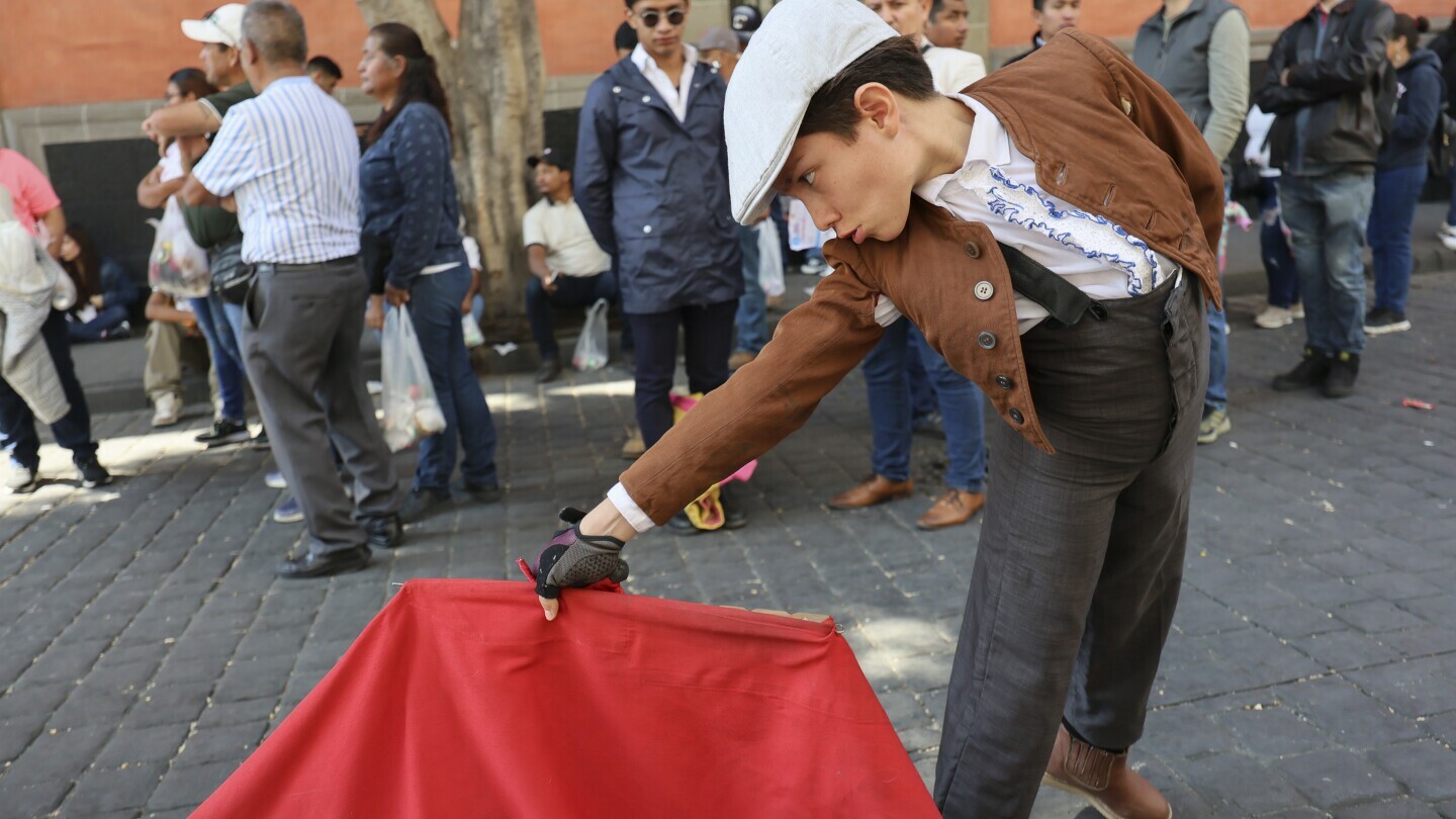 A young supporter of bullfighting joins a demonstration in support of bullfighting outside Mexico City's Congress where lawmakers are expected to debate its continuation in Mexico City, Tuesday, March 18, 2025. (AP Photo/Ginnette Riquelme)