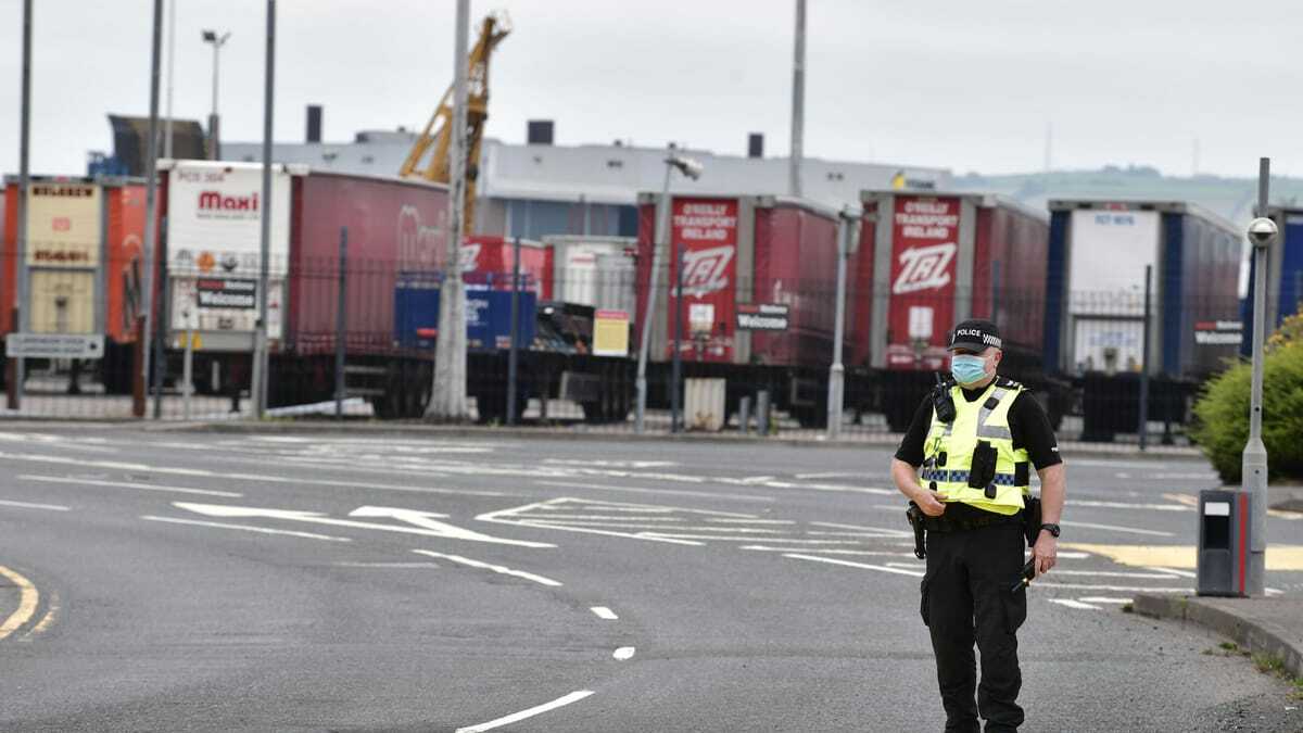 Police officers watch on as Loyalists hold a protest against the Northern Ireland Protocol and the so called Irish sea border at Belfast Harbour on July 3, 2021 in Belfast. | Charles McQuillan/Getty Images
