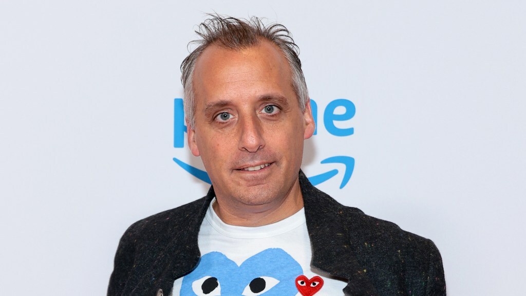 Joe Gatto poses on a red carpet.