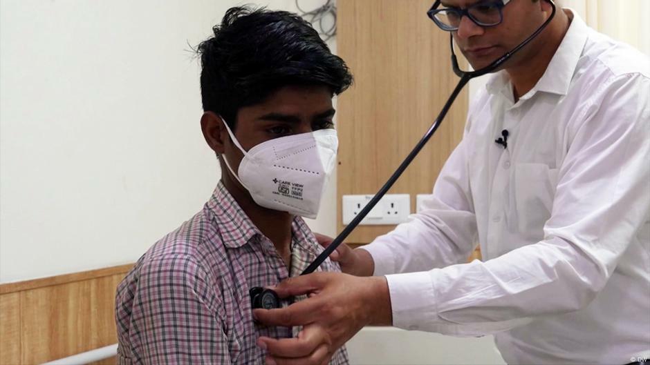 Dr. Loveleen Mangla places a stethoscope on tuberculosis patient Mahesh Kumar's chest