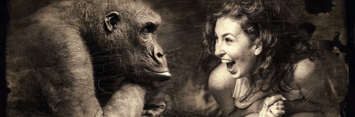 woman telling joke to a gorilla and laughing