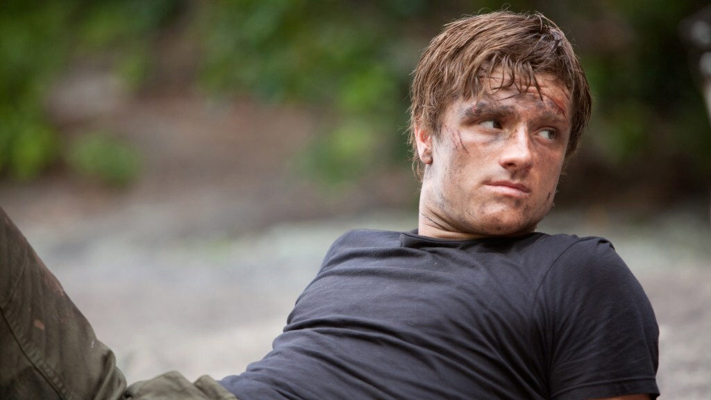Josh Hutcherson lies back with dirt on his face in a still from 'The Hunger Games'