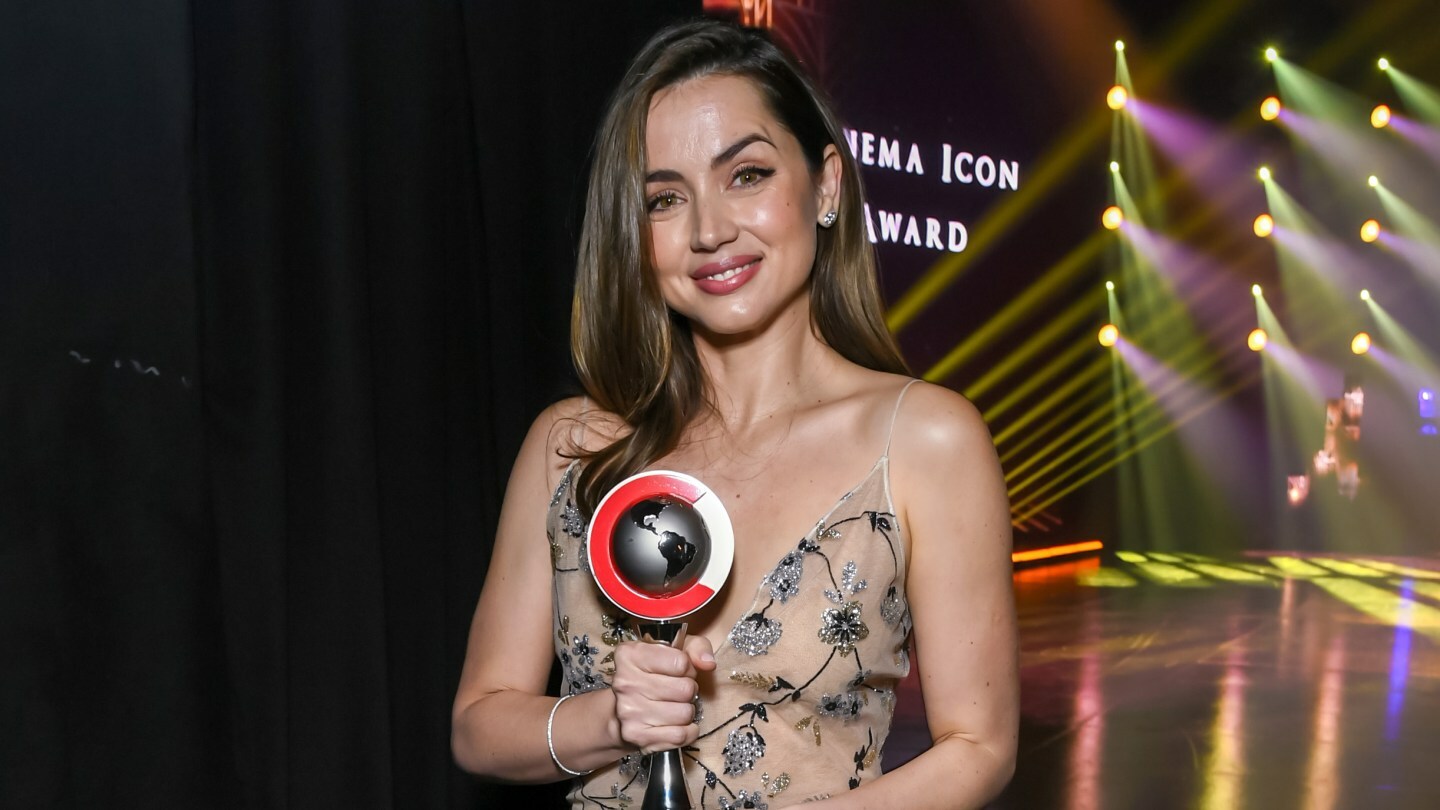 Ana de Armas poses with an award at CinemaCon.