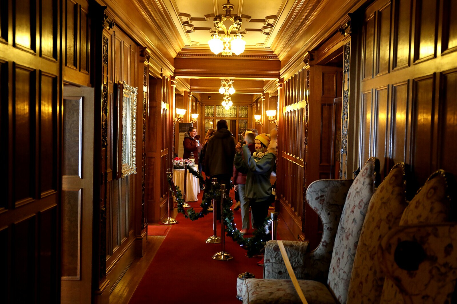 Superior High School student Koda Bosma uses a phone to take a photograph in the hallway at Glensheen Mansion