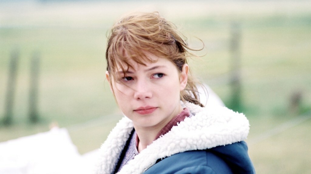 Michelle Williams wears a shearling jacket in front of a field in 'Brokeback Mountain'.