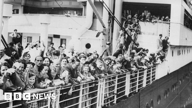 Jewish refugees aboard the MS St. Louis ocean liner wave as they arrive in Antwerp, Belgium.