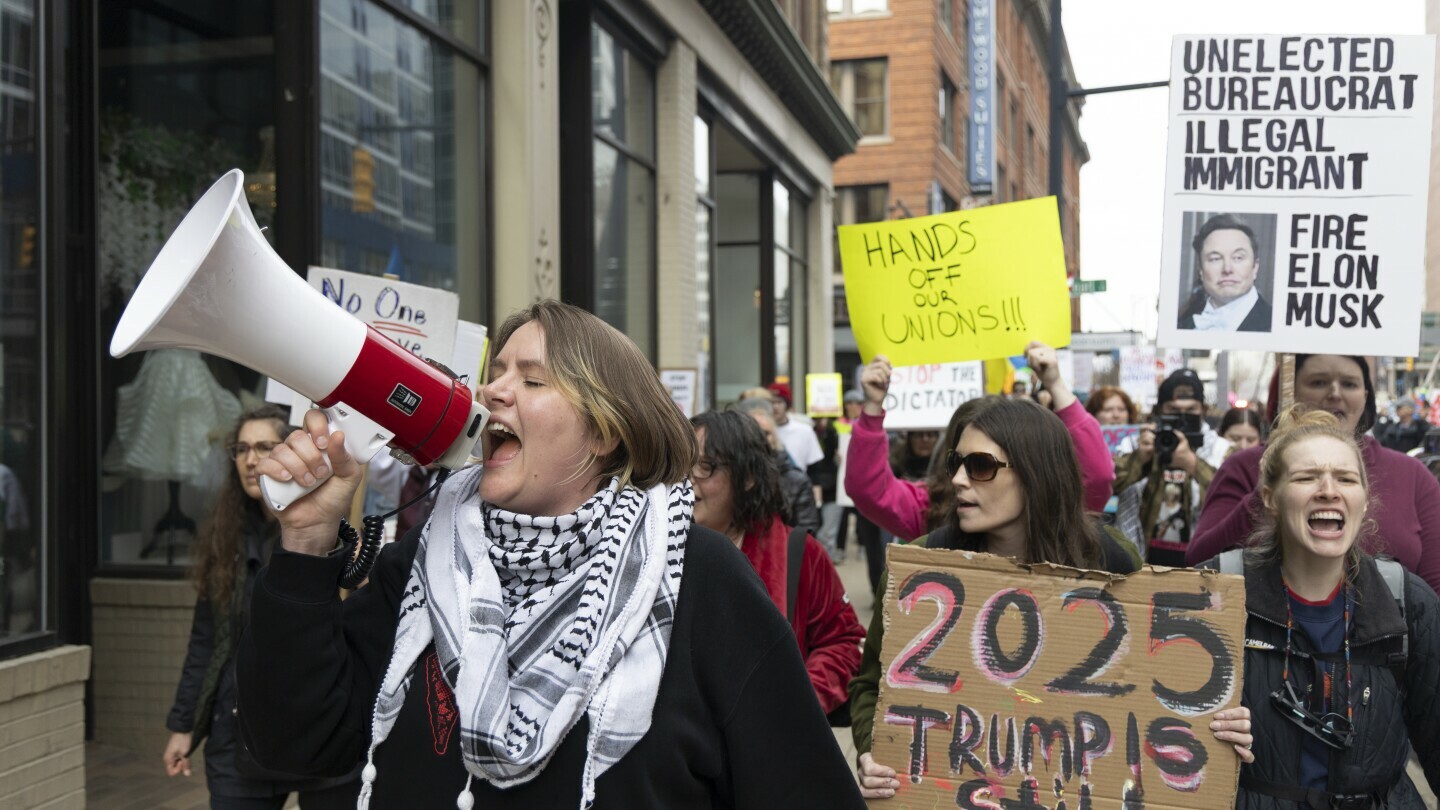 Community organizer Emerson Wolfe leads a march hosted by Indivisible Greater Grand Rapids down Ottawa Avenue during a Hands Off! rally, April 5, 2025, in Grand Rapids, Mich. (Arthur H. Trickett-Wile/The Grand Rapids Press via AP)