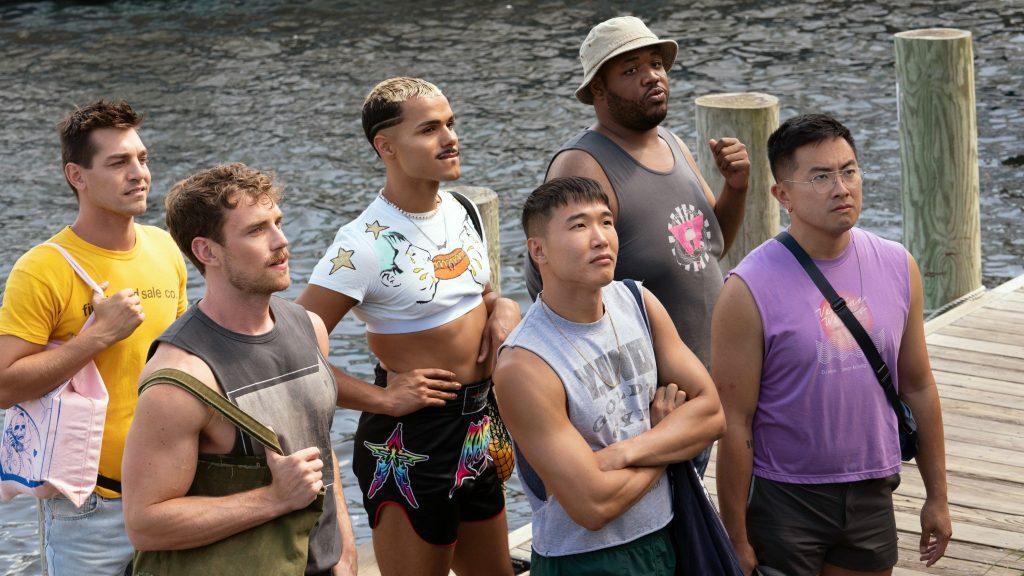 Matt Rogers, Zane Phillips, Tomas Matos, Joel Kim Booster, Torian Miller and Bowen Yang stand on a dock in a still from 'Fire Island'