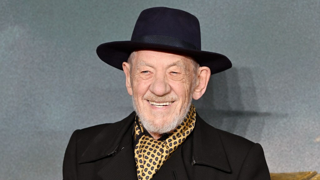 Sir Ian McKellen poses on a red carpet.