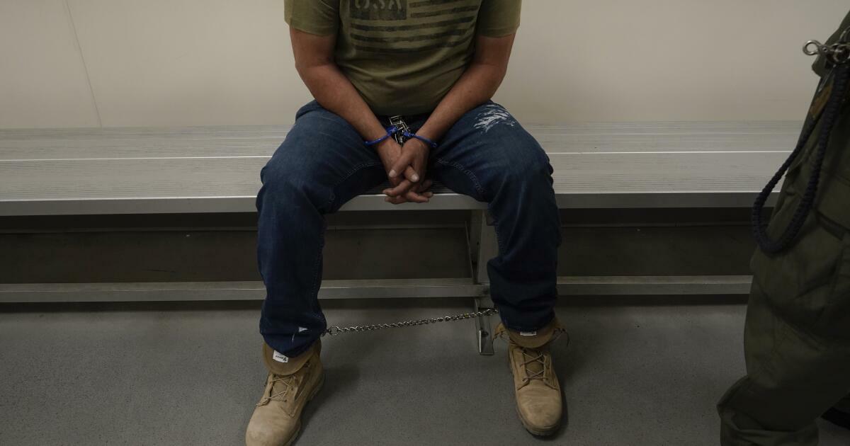 FILE - An immigrant considered a threat to public safety and national security waits to be processed by U.S. Immigration and Customs Enforcement agents at the ICE Metropolitan Detention Center in Los Angeles, after an early morning raid, June 6, 2022. The Supreme Court said Friday, June 23, 2023, that it will no longer stand in the way of a long-blocked Biden administration policy to prioritize the deportation of immigrants who are deemed to pose the greatest public safety risk or were picked up at the border. (AP Photo/Damian Dovarganes, File)