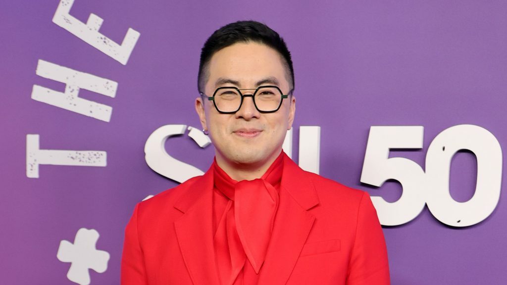 Bowen Yang poses on a red carpet.