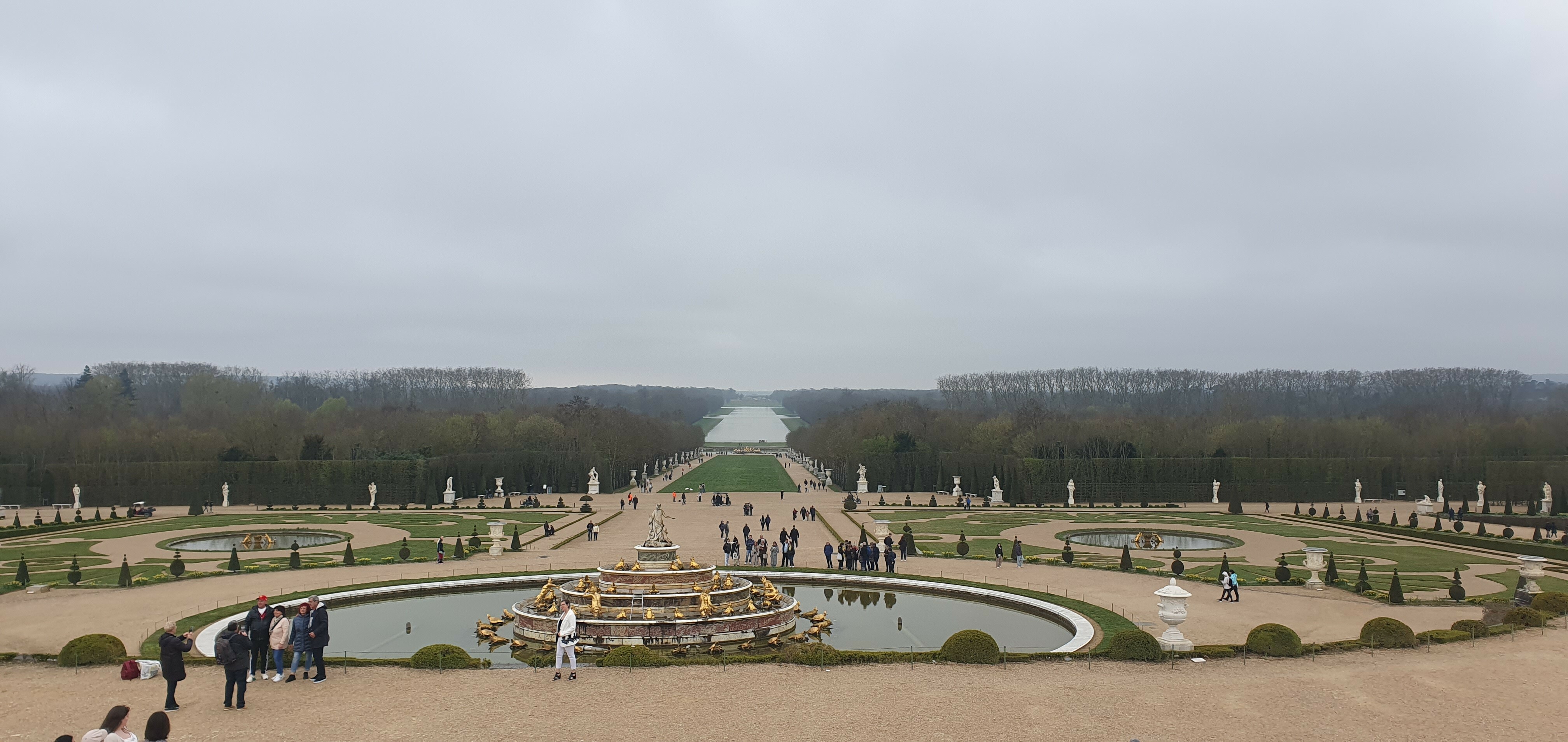 View of the gardens of Versailles on a cloudy day.