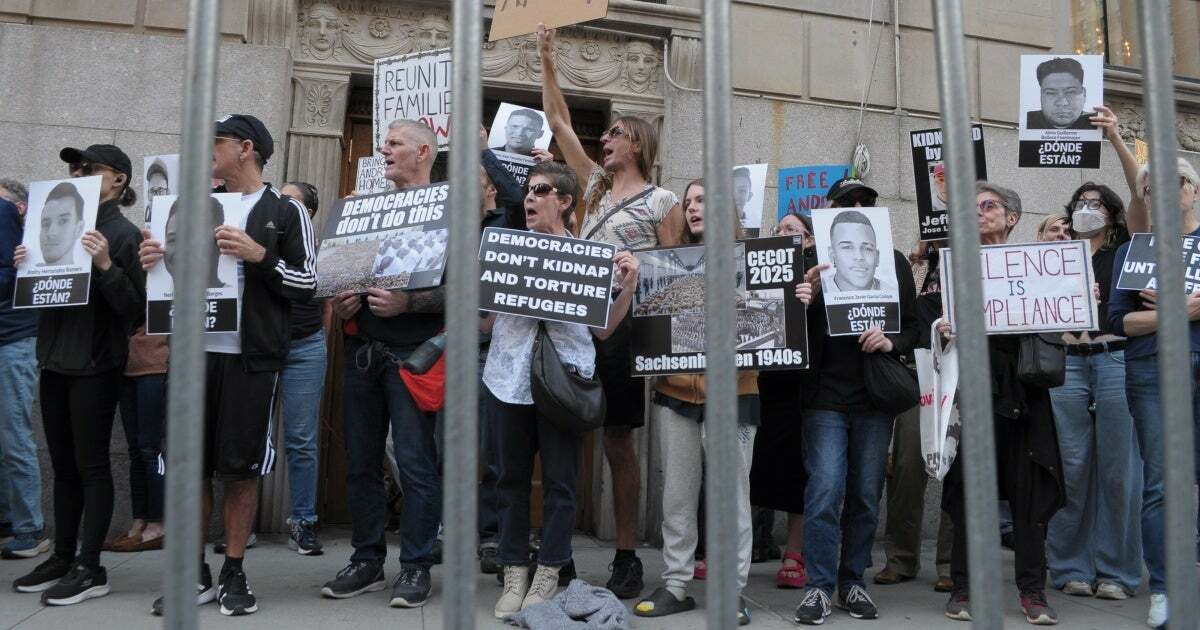 Demonstrators holding up placards