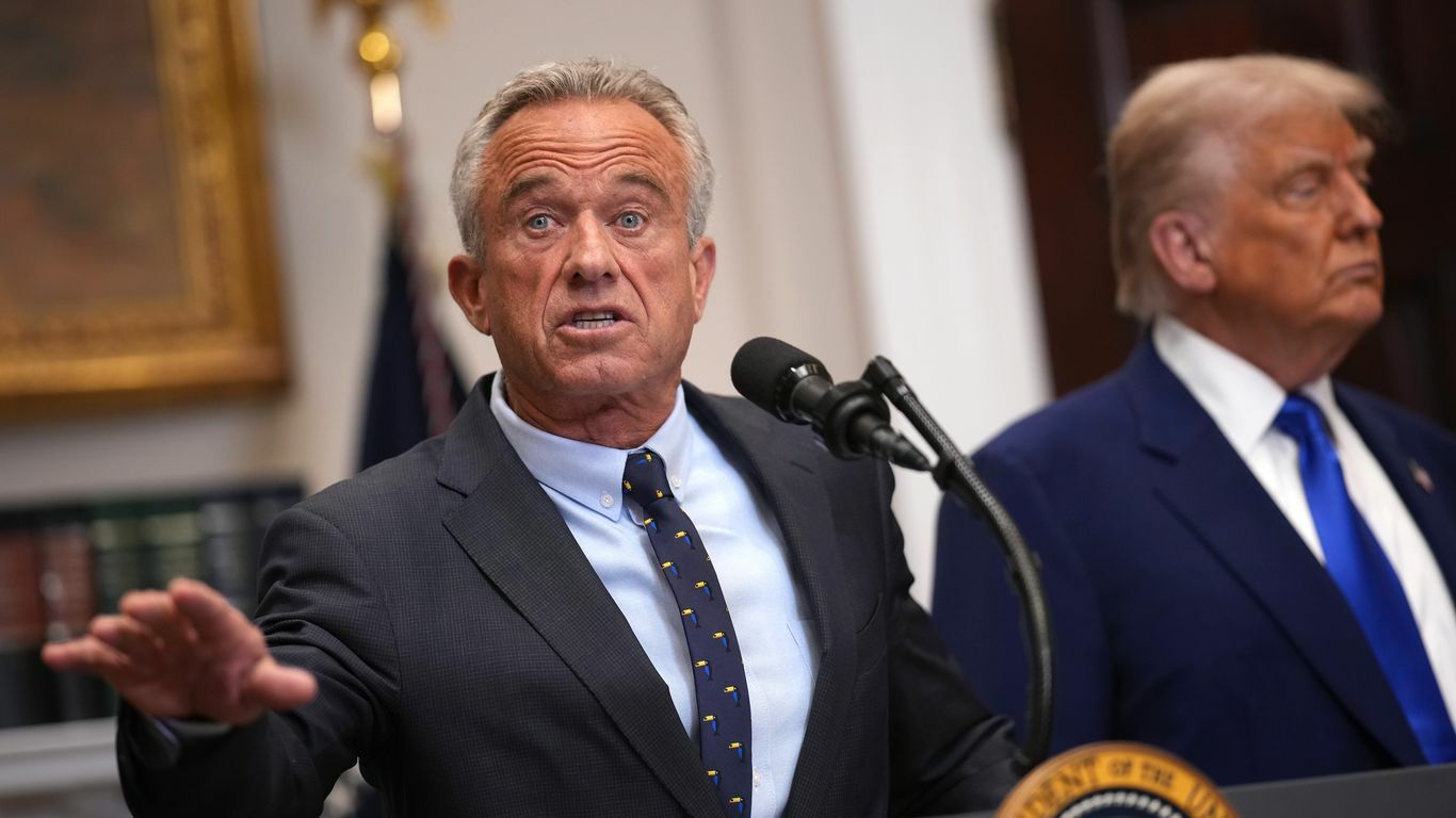 Secretary Robert F. Kennedy Jr. gestures as he speaks alongside President Trump during a press conference in the Roosevelt Room of the White House.