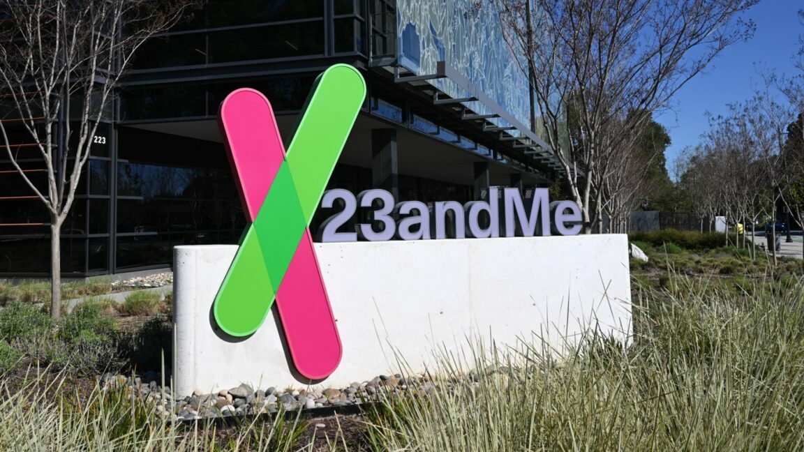 A sign with the 23andMe logo placed in front of a building that serves as the company's headquarters.