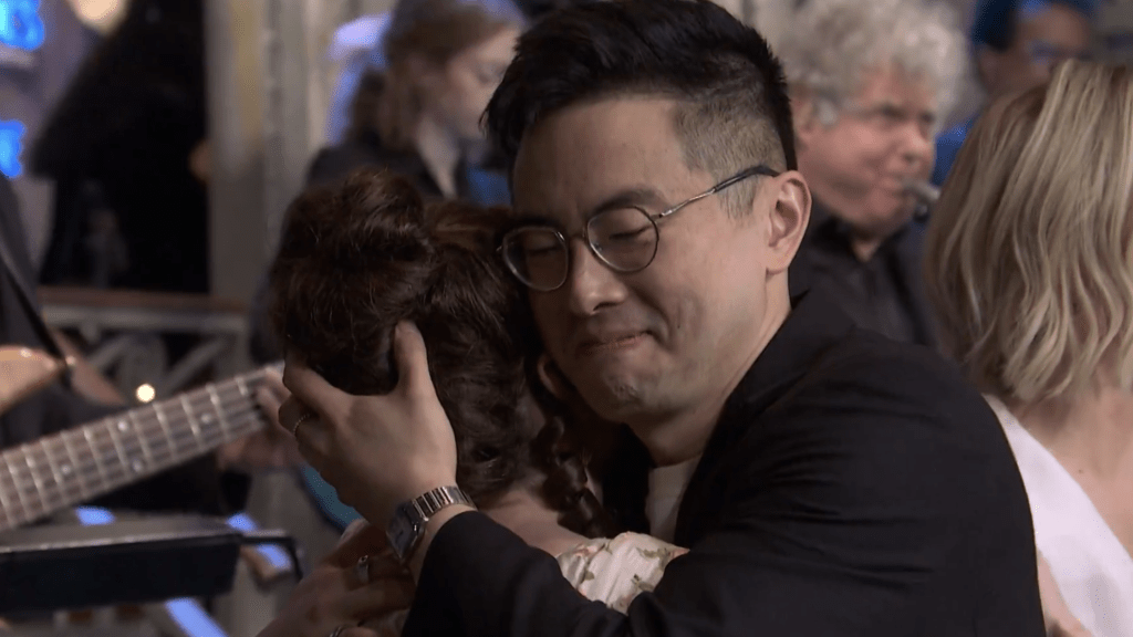 Bowen Yang hugs Sarah Sherman on the 'Saturday Night Live' Season 50 finale curtain call.
