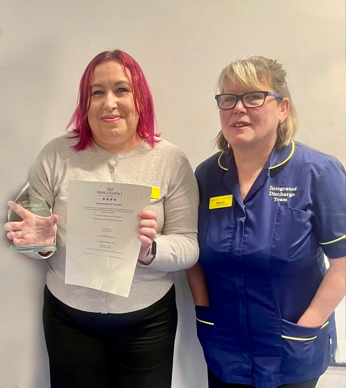 Natalie Chambers, left, with her award for helping the homeless, alongside colleague Marcia Coutts