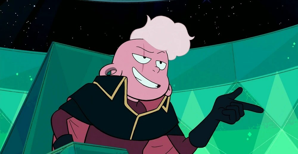 A pink teenage boy wearing a black and maroon cape while sitting in at a console in a green space ship.