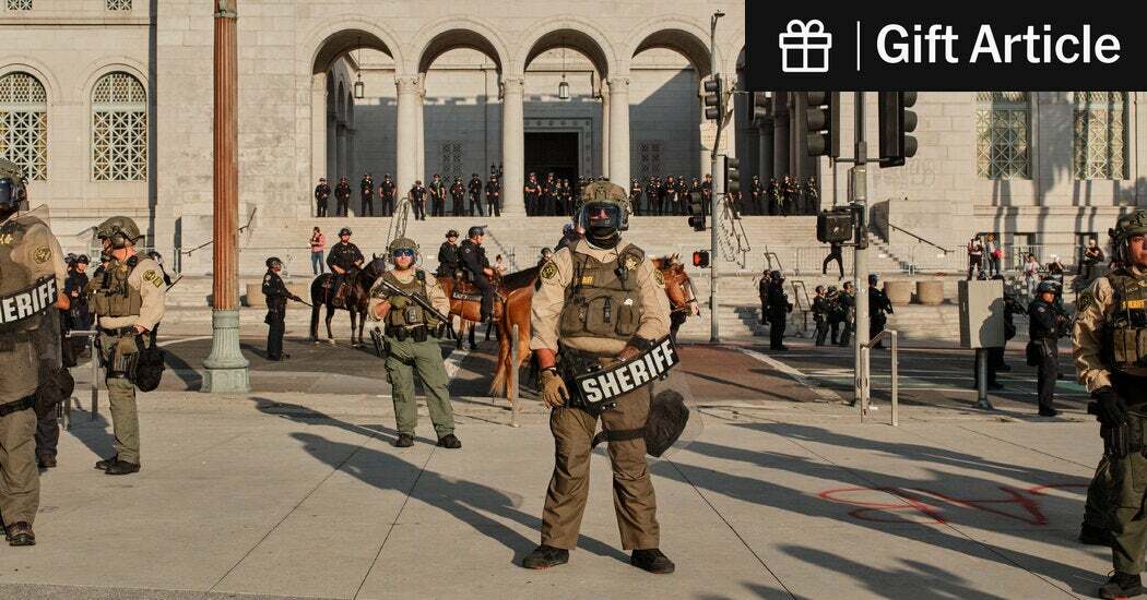 Officers outside City Hall in Los Angeles. The attorney general, Pam Bondi, has vowed to pursue federal charges against anyone who violates the law at demonstrations.