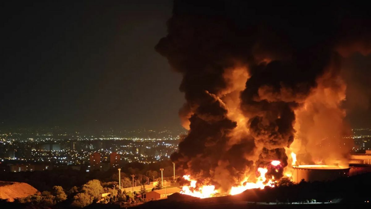 Fire and smoke rise into the sky after an Israeli attack on the Shahran oil depot on Sunday. Getty Images