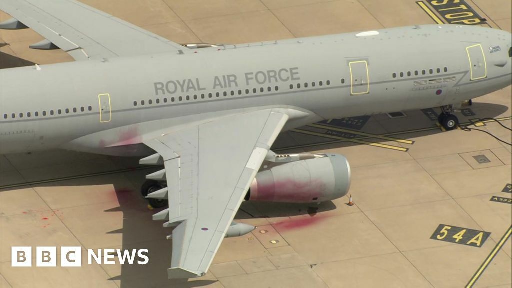 Red paint is seen on and around a Royal Air Force plane