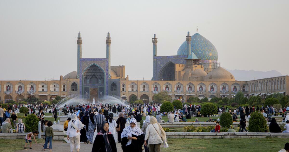 People stroll near the Shah Mosque, also known as Imam Mosque, at Naqsh-e Jahan Square in Isfahan, Iran in September  2024. 