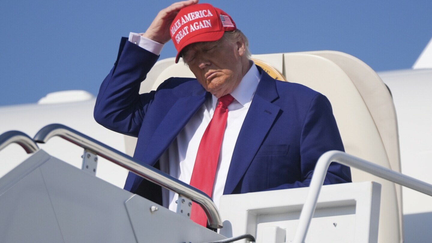 President Donald Trump adjusts his hat as he arrives on Air Force One at Joint Base Andrews, Md., Saturday, June 21, 2025. (AP Photo/Manuel Balce Ceneta)