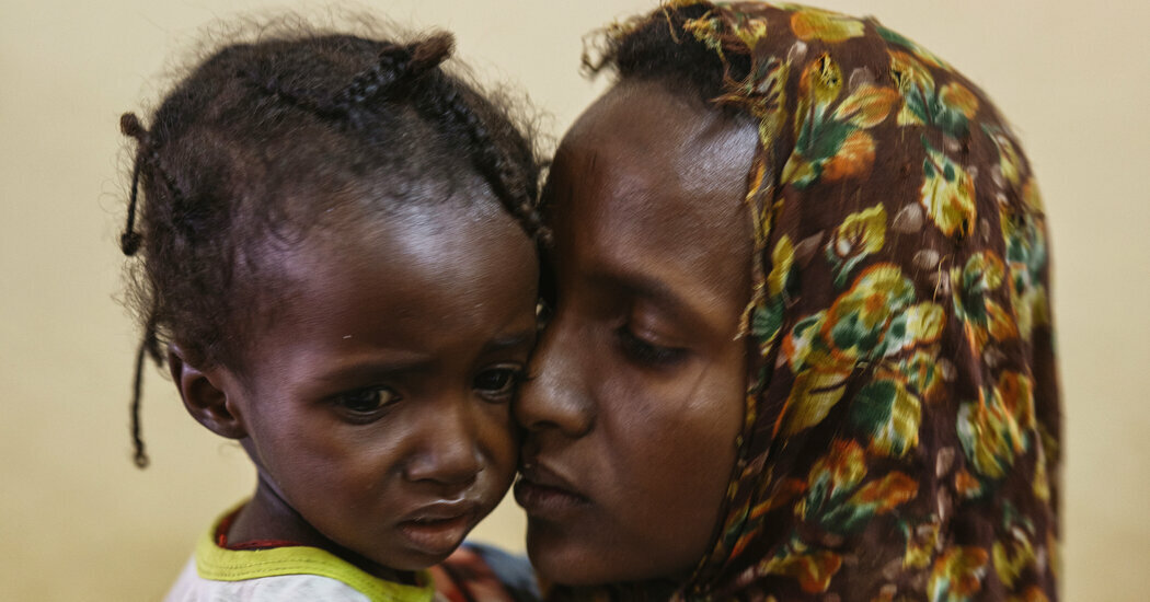 Khadiga Adam holds her severely malnourished 2-year-old daughter, Rashida, in South Sudan.