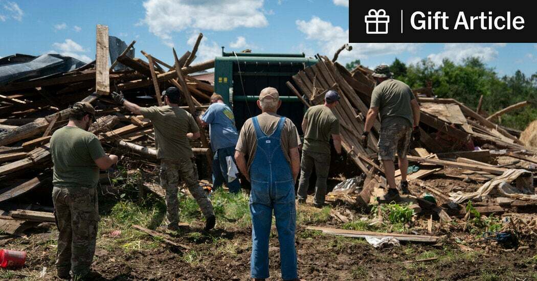 Members of the Christian Rangers and United Cajun Navy helped clear debris at the home of Glenn Farmer, center, in Mount Victory, Ky., after tornadoes tore through last month.