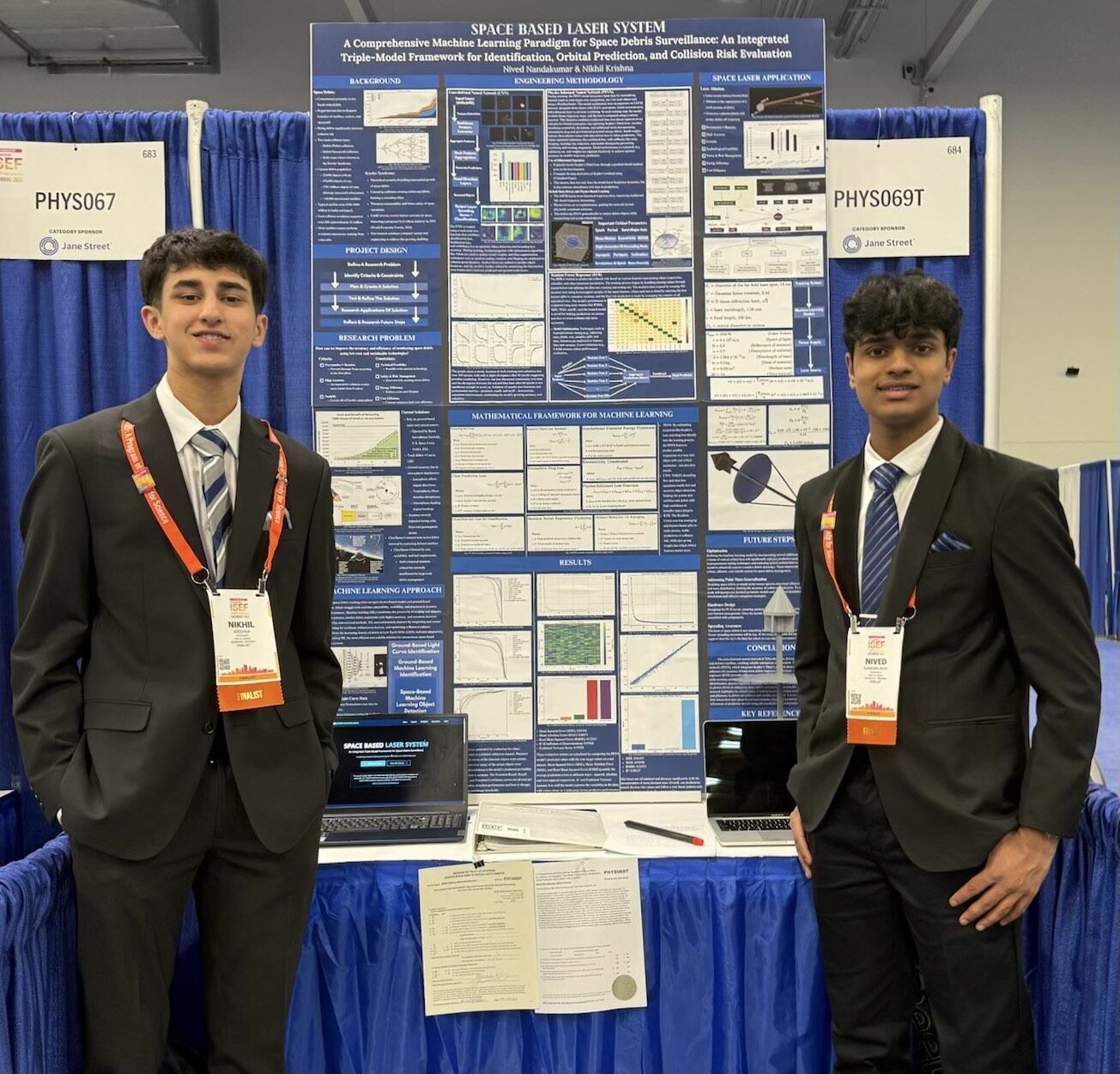 two boys stand in front of a science project