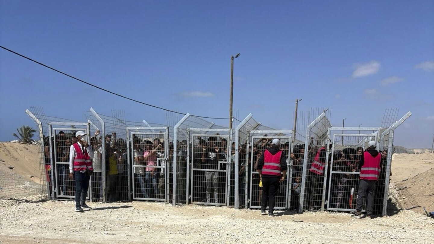 This photo, provided by an American contractor on condition of anonymity because they were revealing their employers’ internal operations, shows Palestinians behind gates before entering a food distribution site operated by the Gaza Humanitarian Foundation in May 2025, shortly after the start of the organization's distribution sites. (AP Photo)
