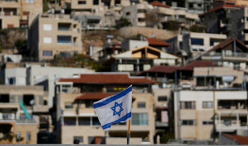 An Israeli flag flies on a roof in the town of Majdal Shams, near the so-called Alpha Line that separates the Israeli-occupied Golan Heights from Syria, Sunday, Dec. 15, 2024. (AP)