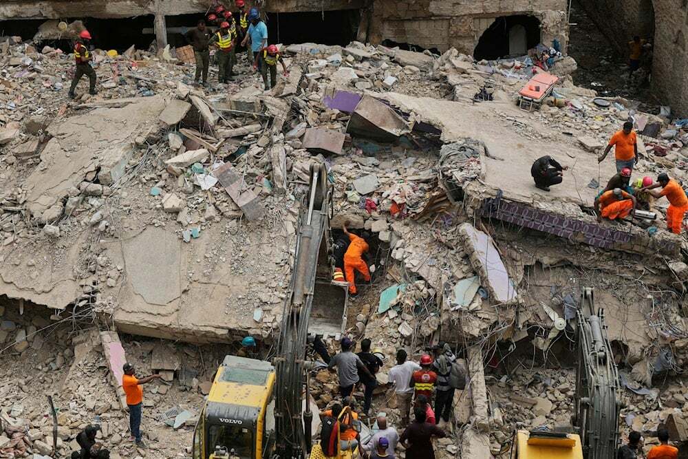 Rescue workers clear rubble with heavy machinery to search for survivors and bodies at the site of multi-story building collapsed, in Karachi, Pakistan, Friday, July 4, 2025 (AP)