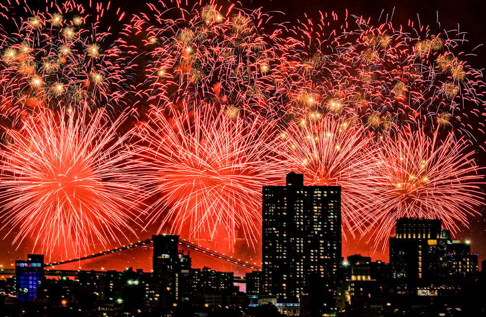 Fireworks explode over the East River and Brooklyn Bridge during the Macy's 4th of July Fireworks Show on July 4, 2025 in New York (AP)