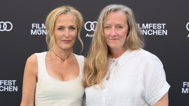 Actress Gillian Anderson (l) and author Raynor Winn (r) pose before the event on the Filmfest München carpet. Anderson receives the CineMerit Award in the Deutsches Theater at the 42nd Munich Film Festival.