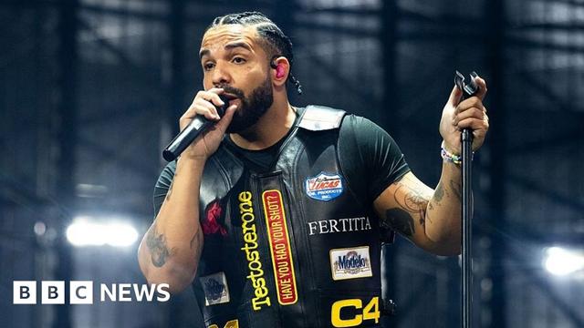 Drake holding a microphone stand