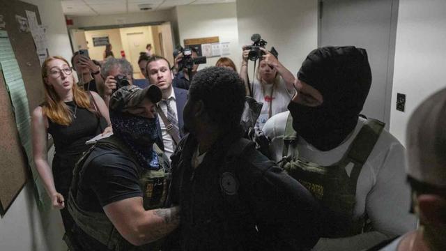 A person is detained by federal agents outside an immigration court at the Jacob K. Javits federal building on Thursday, July 3, 2025, in New York. (AP Photo/Yuki Iwamura)