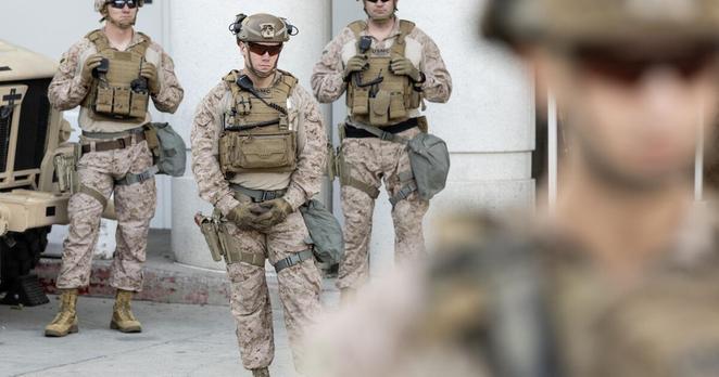 Los Angeles, CA - July 17: Marines guard the Federal Detention Center on Thursday, July 17, 2025 as people protest against immigration enforcement in Los Angeles, CA. (Luke Johnson / Los Angeles Times)