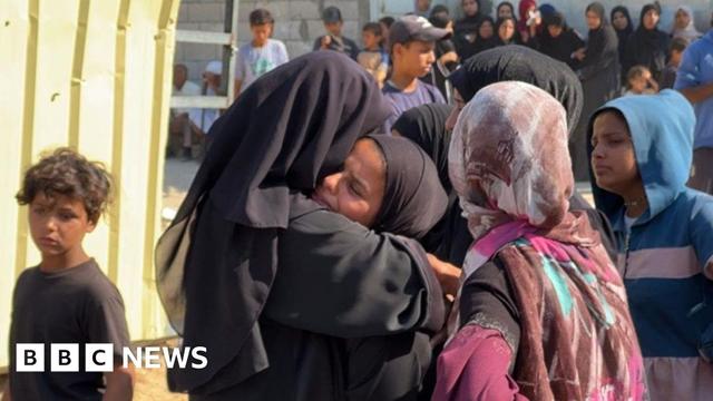 Mary Sheikh al-Eid's family is comforted after her body is brought to Nasser Hospital in Khan Younis, southern Gaza (24 July 2025)